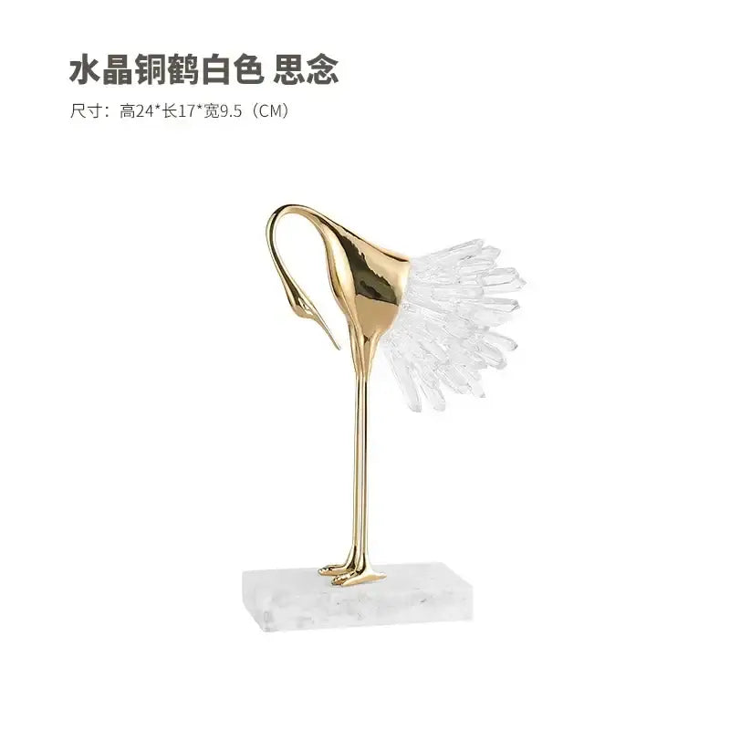 A sleek gold-toned golden bird agate crane statue with crystal wing on white marble base for home decor