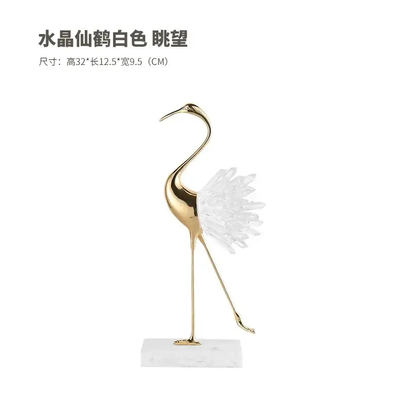 A sleek gold-toned bird agate marble crane statue with crystalline white feathers on a marble base for home decor