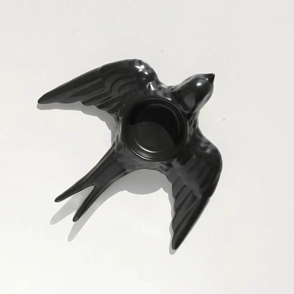 Black ceramic swallow-shaped candle holder tray with glossy finish and circular opening for wedding decor