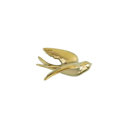 Golden bird swallow sculpture with sleek reflective surface and detailed wings for decorbites golden bird wall decor