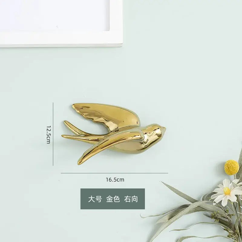 Golden bird swallow glossy ceramic wall decor with sleek wings and streamlined body for living room decorbites golden bird