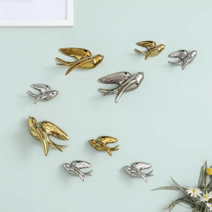 Shiny gold and silver metal bird swallow sculpture wall decor by decorbites ideal for living room display