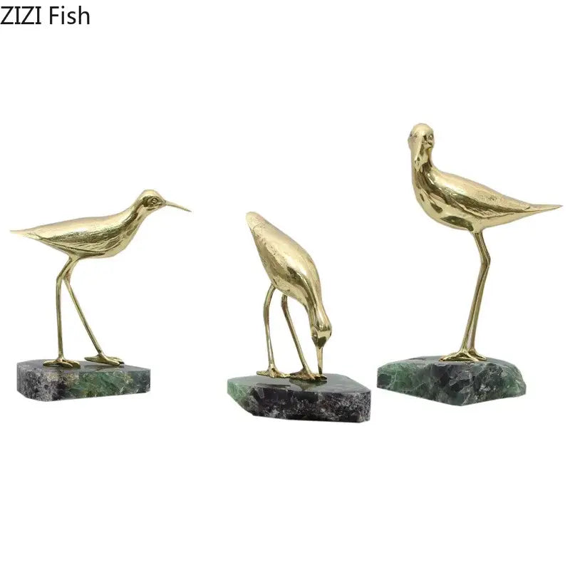 Three golden brass bird desk ornaments on polished green marble bases for elegant living room decoration
