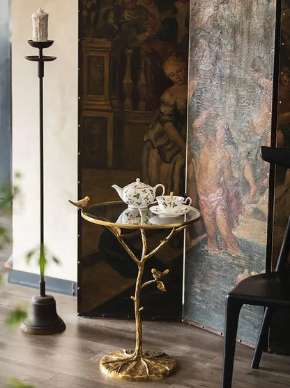 Golden brass bird tree side table with glass top and decorative birds for living room decorbites brass bird design