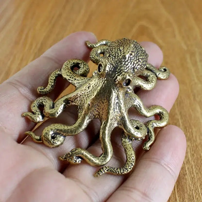 Golden brass octopus sculpture with textured skin and coiled tentacles for living room decor by decorbites