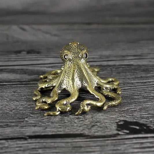 Golden brass octopus sculpture with textured skin and black bead eyes for elegant living room decor by decorbites