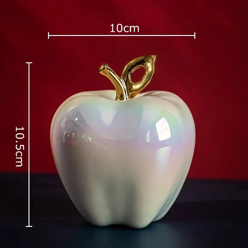 Iridescent white ceramic apple sculpture with golden stem for living room table decor