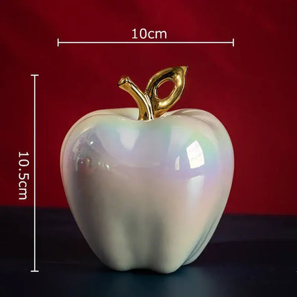Iridescent white ceramic apple sculpture with golden stem for living room table decor
