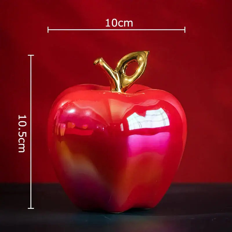 Shiny red ceramic apple sculpture with gold-colored stem perfect for living room table decor