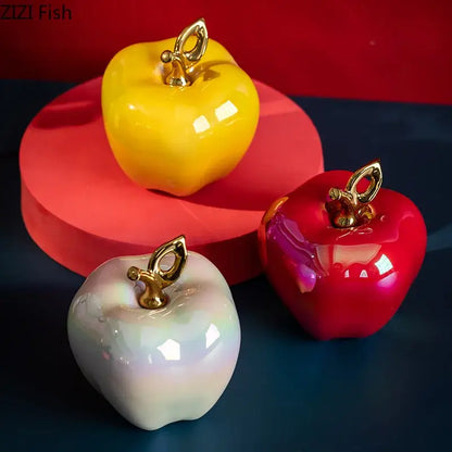 Three glossy ceramic apple sculptures with golden metallic stems and leaves for living room table decor