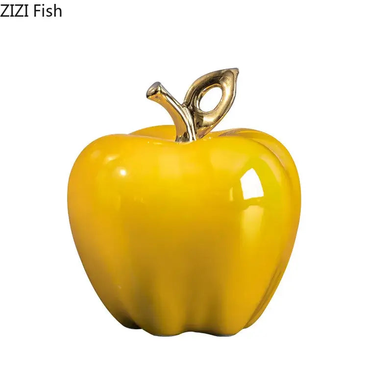 Vibrant yellow ceramic apple sculpture with polished gold stem and leaf for living room table decor