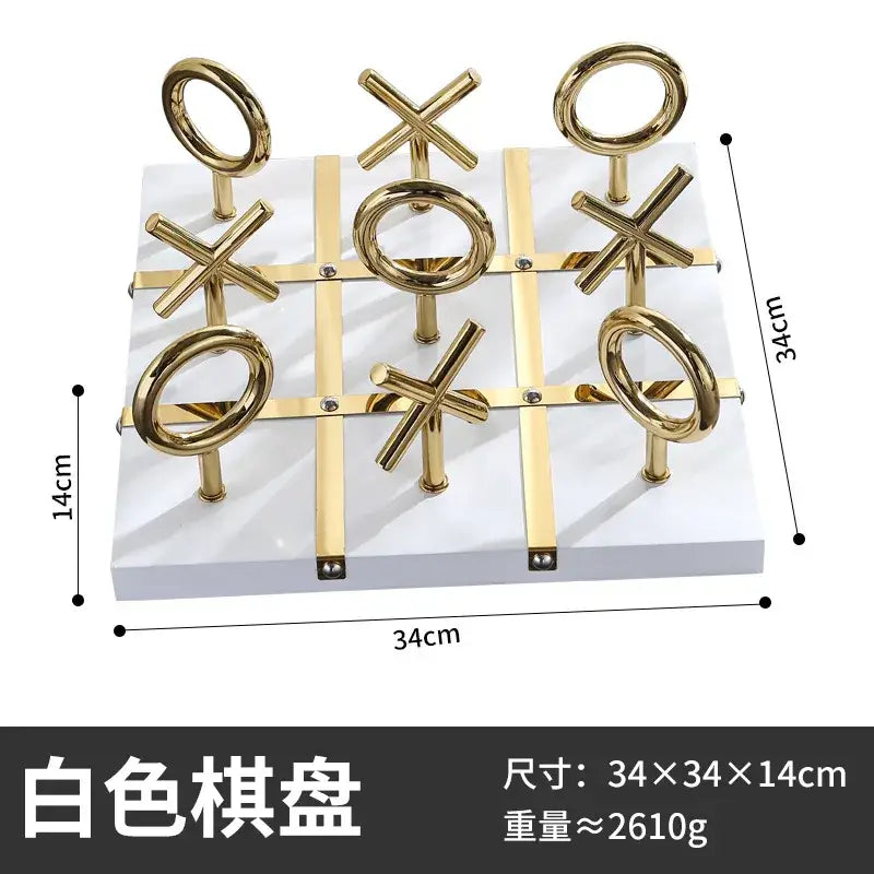 Golden chessboard metal handicraft tic-tac-toe set with gold-colored circular and cross pieces on white base decorbites decor