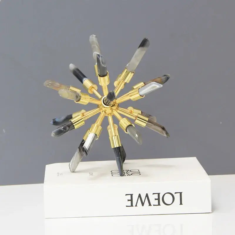 Golden crystal metal sea urchin figurine with translucent arms and black clear tips on white loewe decorbites crystal metal box