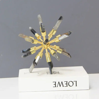 Golden crystal metal sea urchin figurine with translucent arms and black clear tips on white loewe decorbites crystal metal box