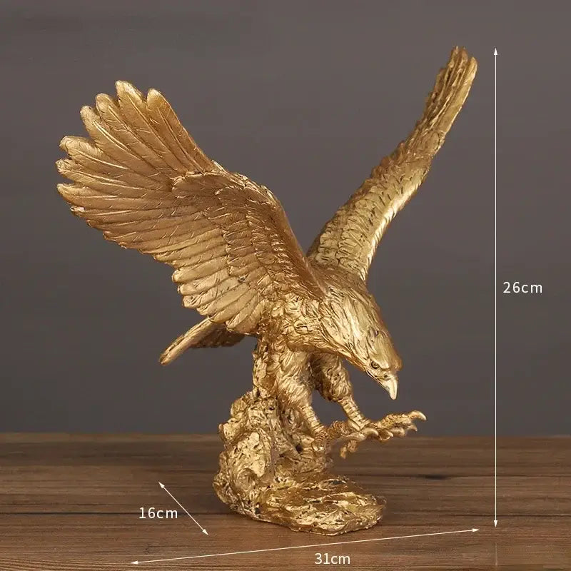 Golden dapeng eagle wings resin statue with detailed feather texture and clawed talons on a rocky base office decor