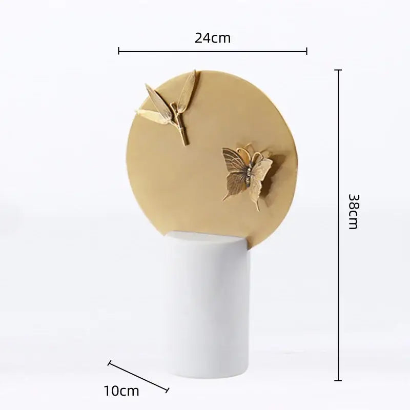 Golden geometric insect figurine set featuring gold-toned butterfly and leaf motifs on a white pedestal for home decor