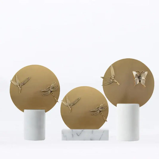 Golden geometric insect figurine set with gold-toned dragonfly and butterfly plaques on white marble bases for home decor