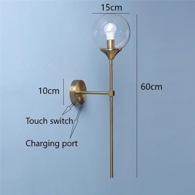 Golden glass ball led wall light featuring a brass-finished modern sconce with a clear glass globe for bedroom decorbites golden glass