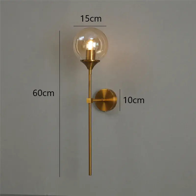 Golden glass ball led wall light with a gold-toned brass sconce and clear glass globe for decorbites golden glass decor