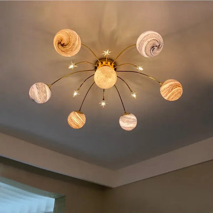 Golden glass ball planet chandelier with swirling marbled globe shades and starburst accents for kids room decorbites glass ball