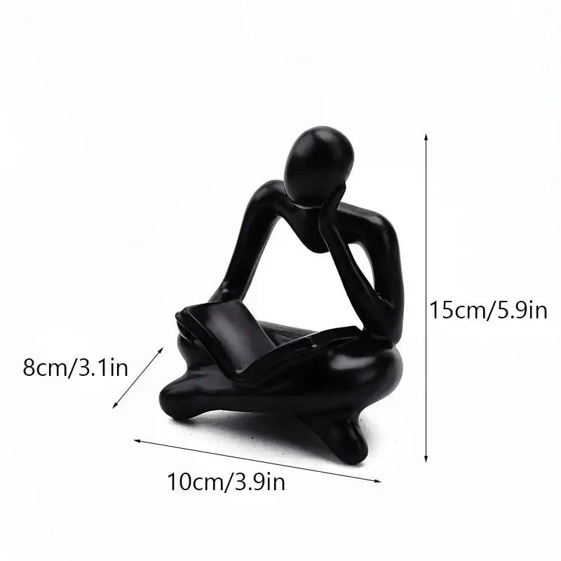 Black glossy resin figurine of a seated thinker with hands on chin and legs crossed for decorbites abstract thinker decor