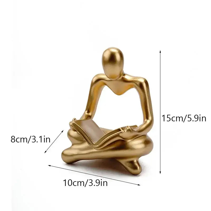 Golden glossy abstract thinker resin figurine of a seated person reading a book ideal for office decorbites decor