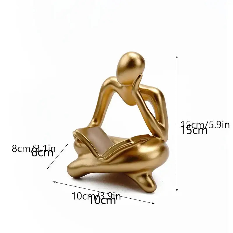 Golden glossy abstract thinker resin figurine showing a seated thinker holding a book for office decorbites decor