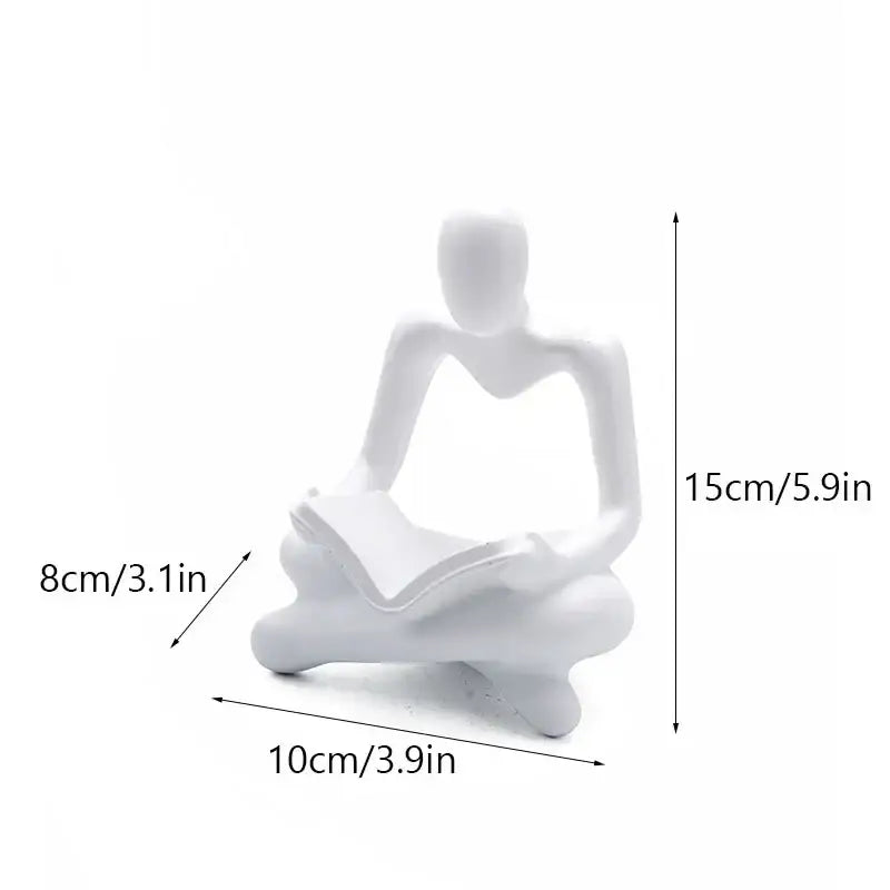 White ceramic resin figurine of seated person reading book golden glossy decorbites abstract thinker office decor