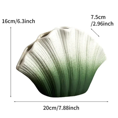 A ceramic vase shaped like a gradient shell with white to deep green ombre and vertical ridges for living room decorbites decor
