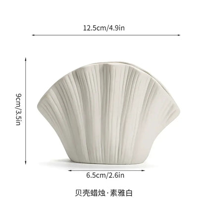 A sleek matte ivory fan-shaped gradient shell ceramic candle holder with vertical ridges for decorbites gradient shell decor