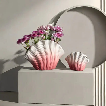 A sleek gradient shell ceramic vase with ribbed texture and scalloped edges in pink to white for living room decor