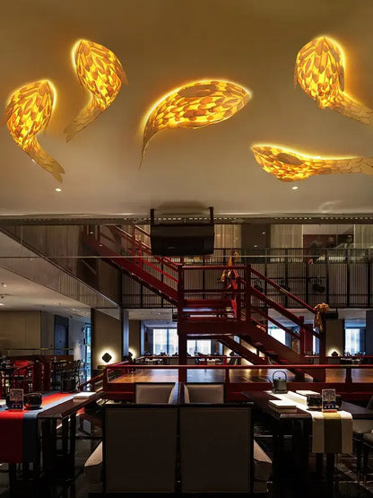 Golden handwoven bamboo led fish wall light with woven texture illuminates restaurant decorbites handwoven bamboo space