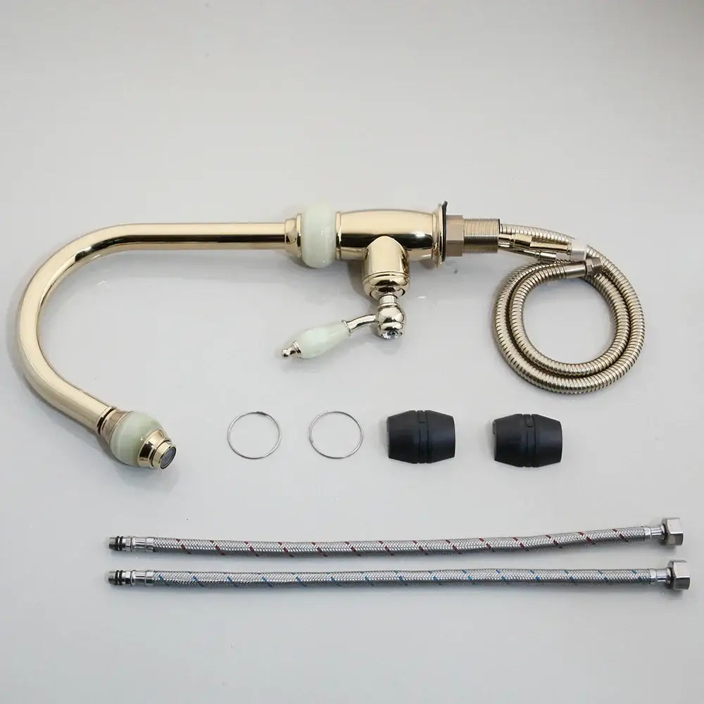 Brass-finished kitchen faucet with golden jade diamond handle, curved spout, swivel pull, and flexible metal hoses