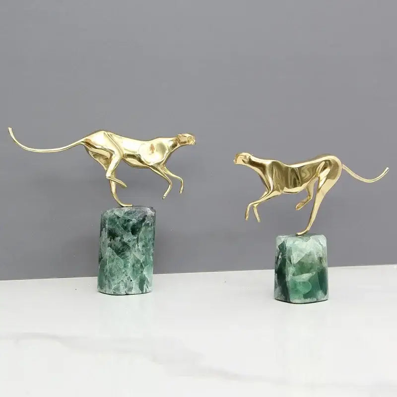 Two golden leopard brass figurines in running pose on polished green marble base decorbites golden leopard decor