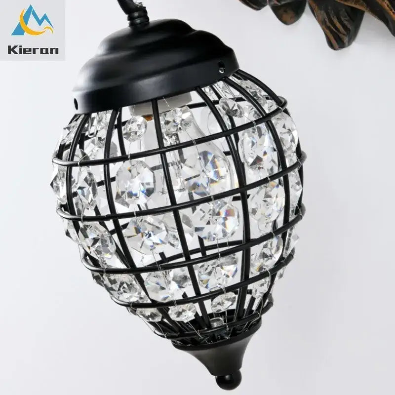 Black metal cage wall lamp adorned with clear faceted beads from decorbites king crystal for king crystal wall decor
