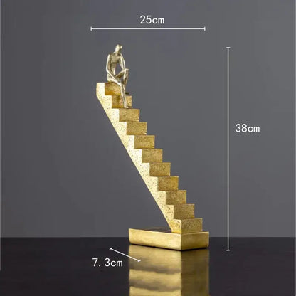 Golden man abstract resin sculpture of a seated figure on textured angled staircase for living room decorbites decor