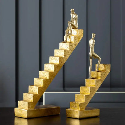 Golden man abstract resin staircase sculpture featuring golden metallic human figures in contemplative poses for living room decorbites decor