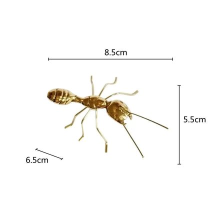 Golden metallic ant decorative figurine with detailed segmented body and articulated legs for home decor