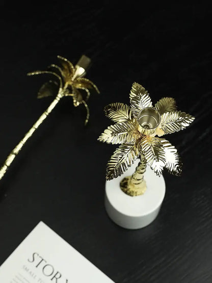 Golden metal candlestick palm tree with intricate leaf detailing and marble base for elegant home decorbites golden metal decor