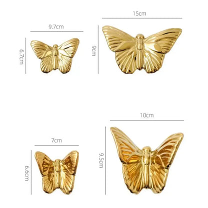 Gold-colored butterfly-shaped metallic pins with detailed wings in a golden metallic butterfly wall decoration set for living room