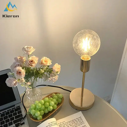 Golden modern led bedside lamp featuring a gold-toned base and textured glass globe bulb for bedroom lighting