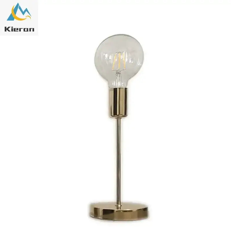 A golden modern led bedside lamp with a sleek brass finish, clear glass globe bulb, and slender metallic stem for bedrooms