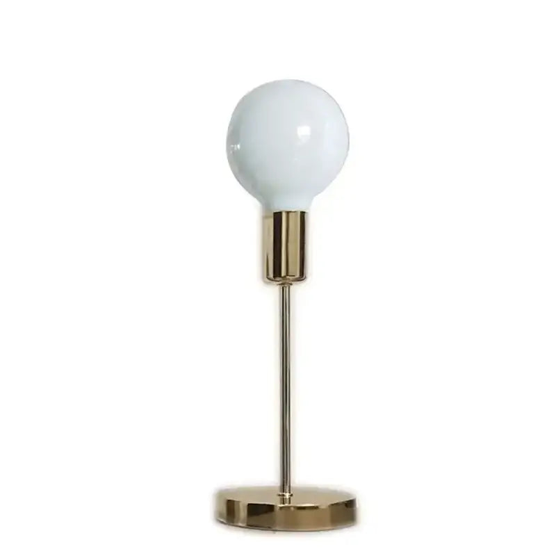 A sleek golden modern led bedside lamp with frosted glass globe and minimalist texture ideal for bedroom lighting