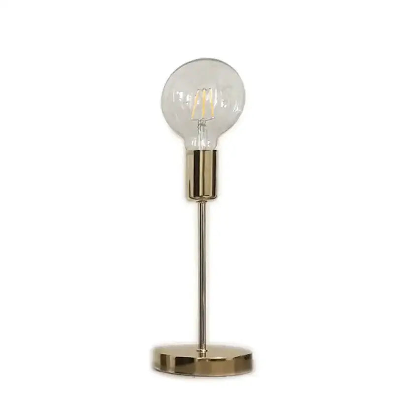 A sleek golden modern led bedside lamp with brass finish, clear glass globe bulb, and slender stem for bedroom use