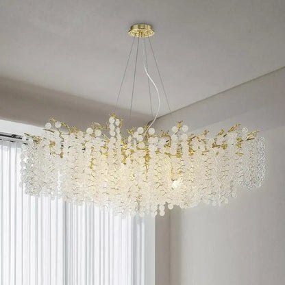A gold-toned crystal chandelier with blossom-like clusters resembling a golden money tree pendant light for living rooms