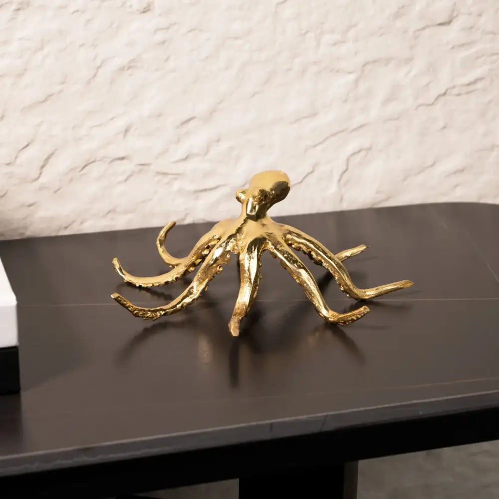 Golden octopus metal sculpture with detailed tentacles and polished reflective surface for living room decorbites decor