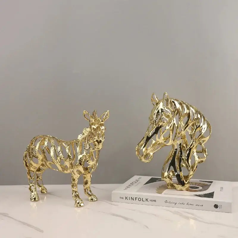 Golden openwork animal sculpture featuring intricate hollow design of horse and zebra for living room decorbites decor