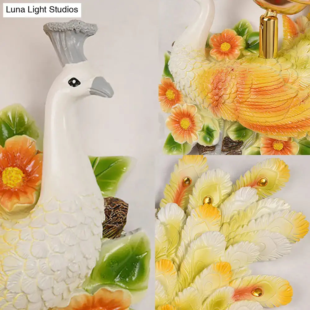 Golden peacock wall light with crystal shade featuring yellow green ceramic body and decorative feathers with beads