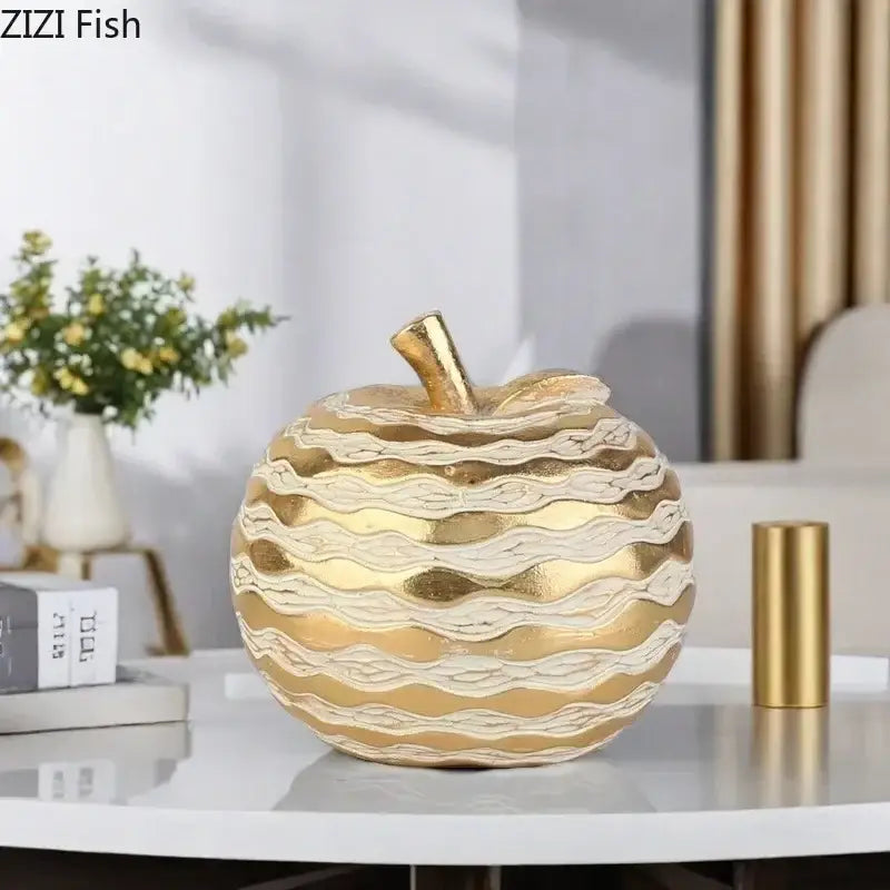 Golden pineapple art statuette with layered wavy textured patterns in metallic gold and cream as elegant desk decoration