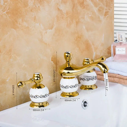 Golden plated bathroom faucet set with white ceramic handles and ornate black scrollwork decorbites golden plated faucet set